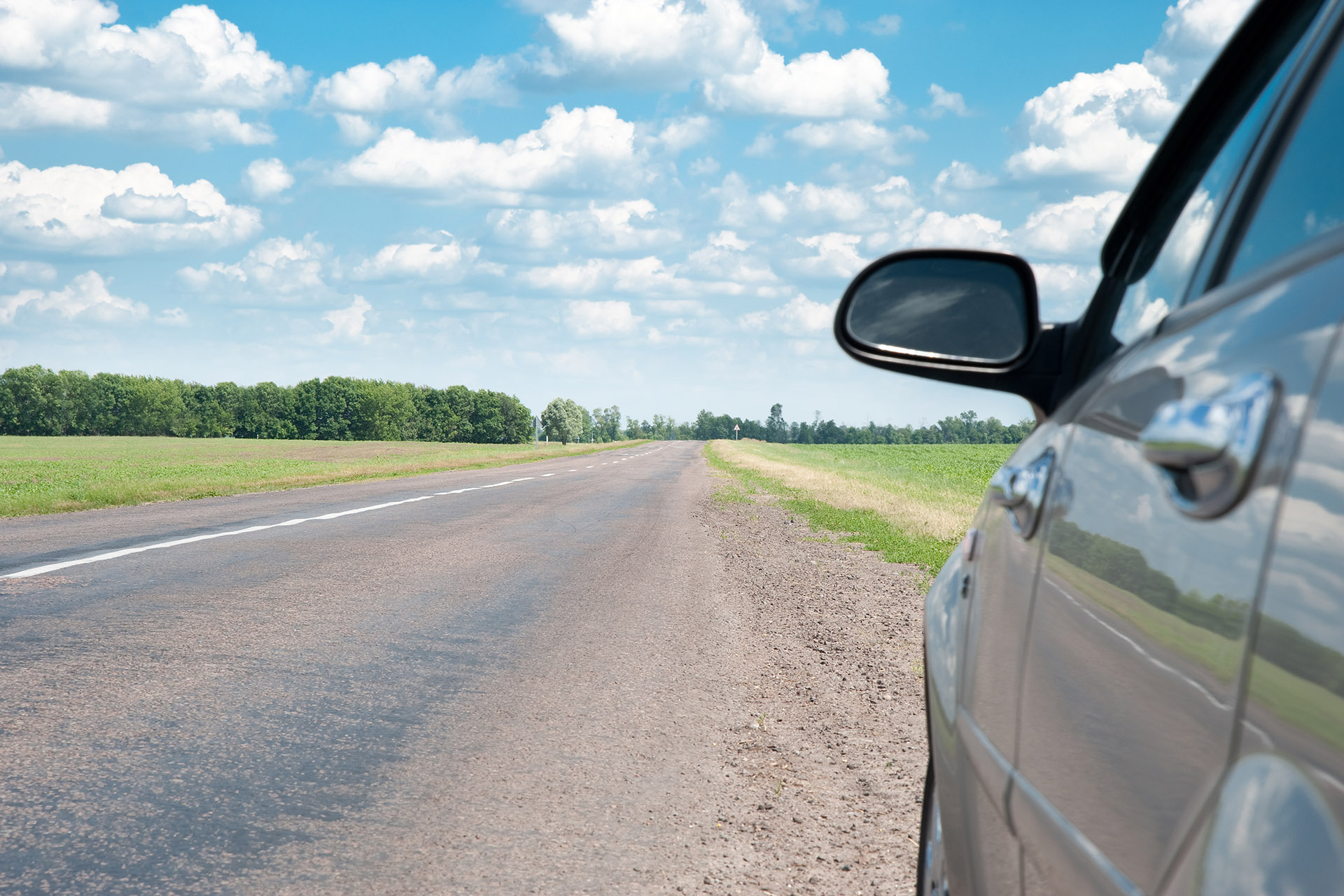 Car Using Right Shoulder of Road to Pass Another Car